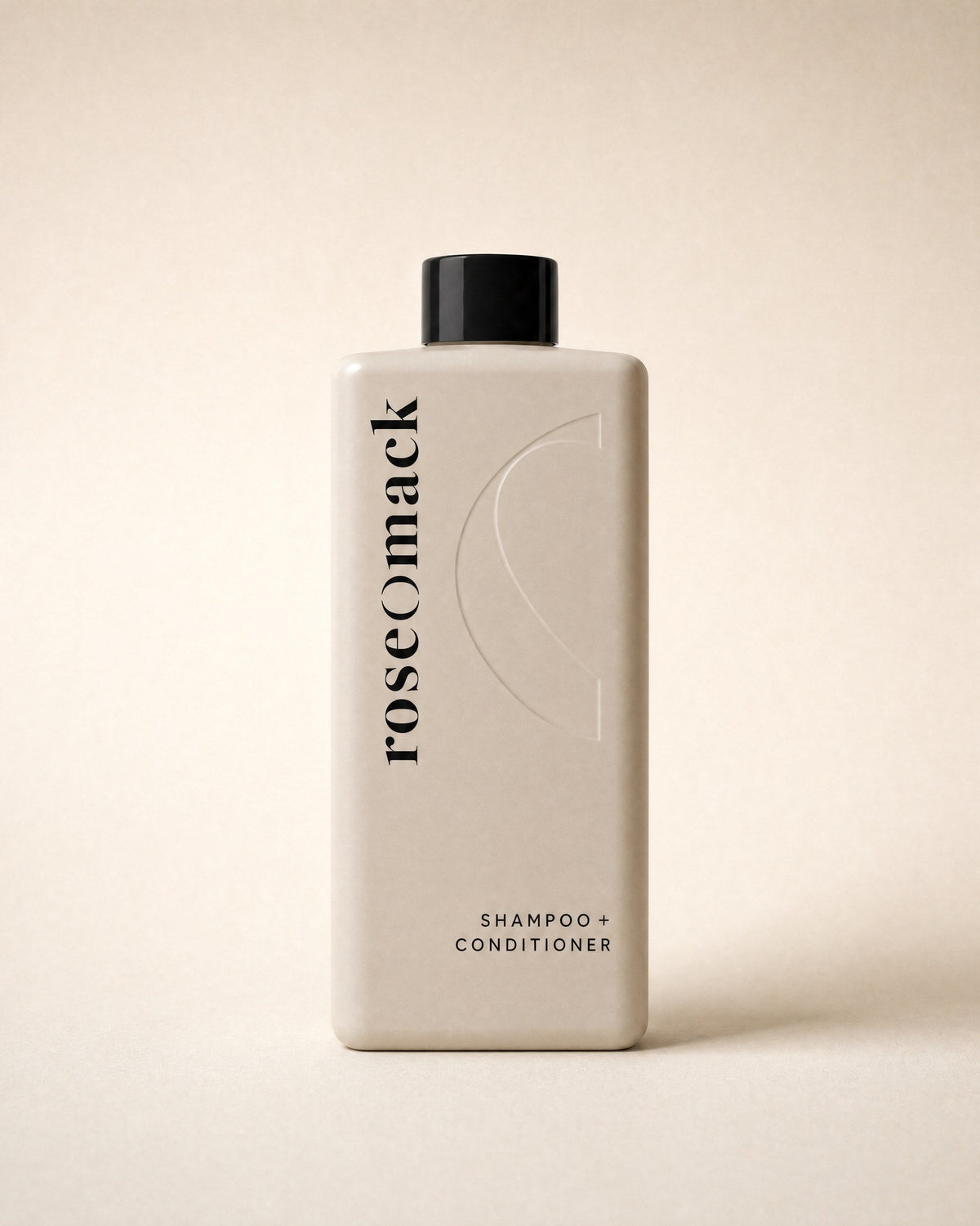 roseomack Shampoo & conditioner seen front on, the wordmark running vertically beside an embossed half O