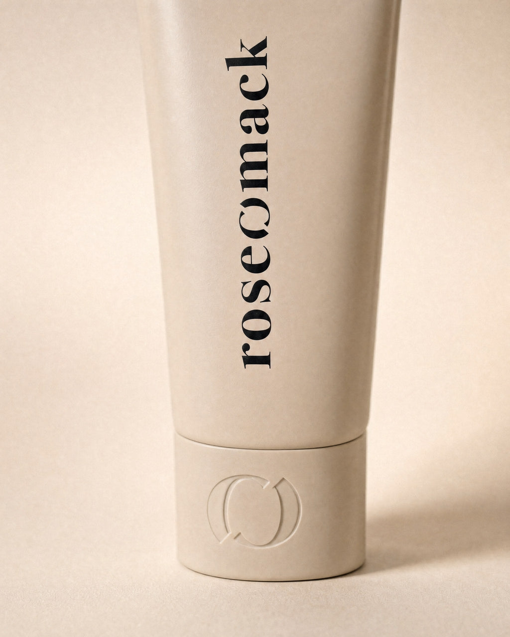Close view of the vertical roseomack wordmark and the broken O embossed on the Sun protection cap