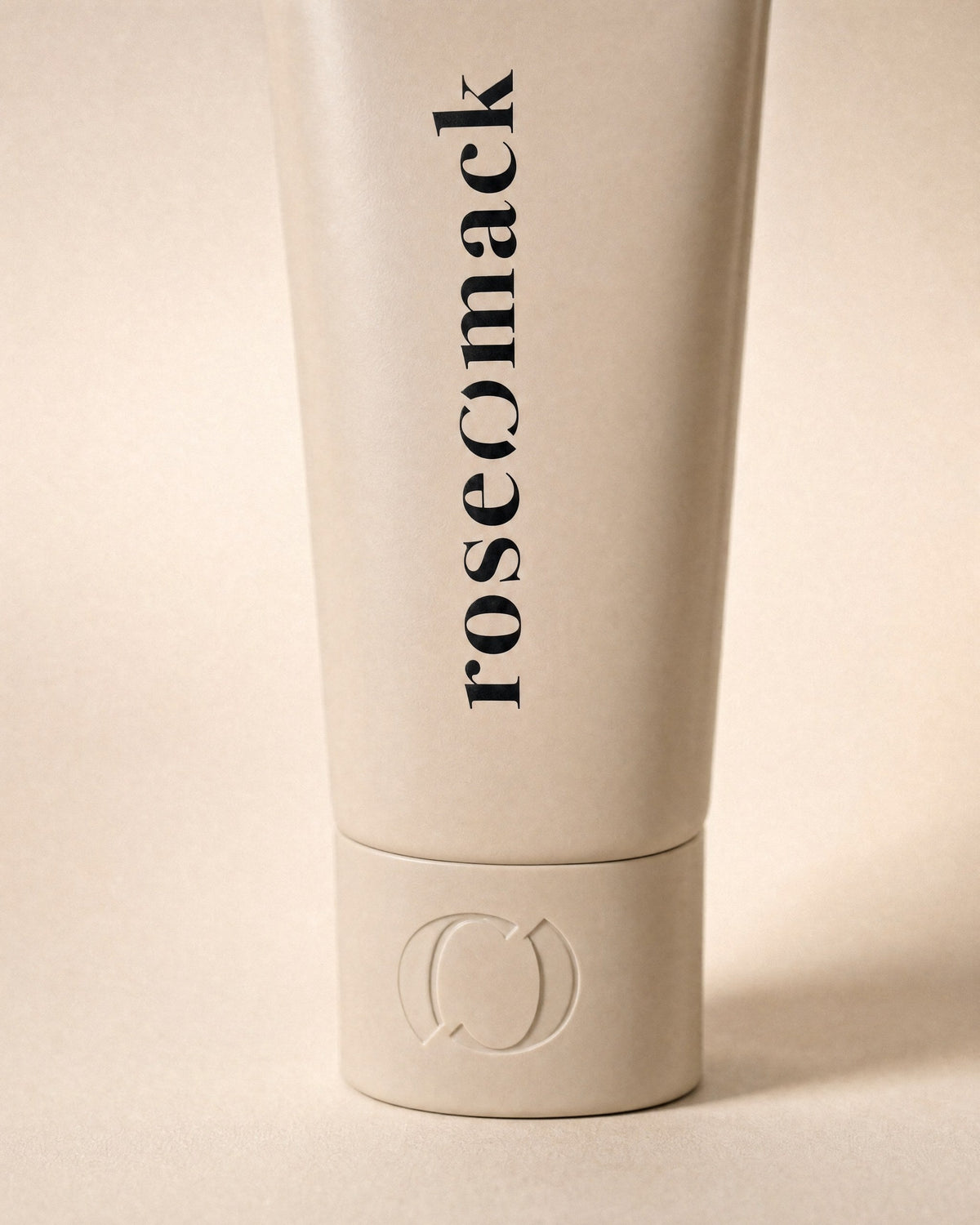 Close view of the vertical roseomack wordmark and the broken O embossed on the Sun protection cap