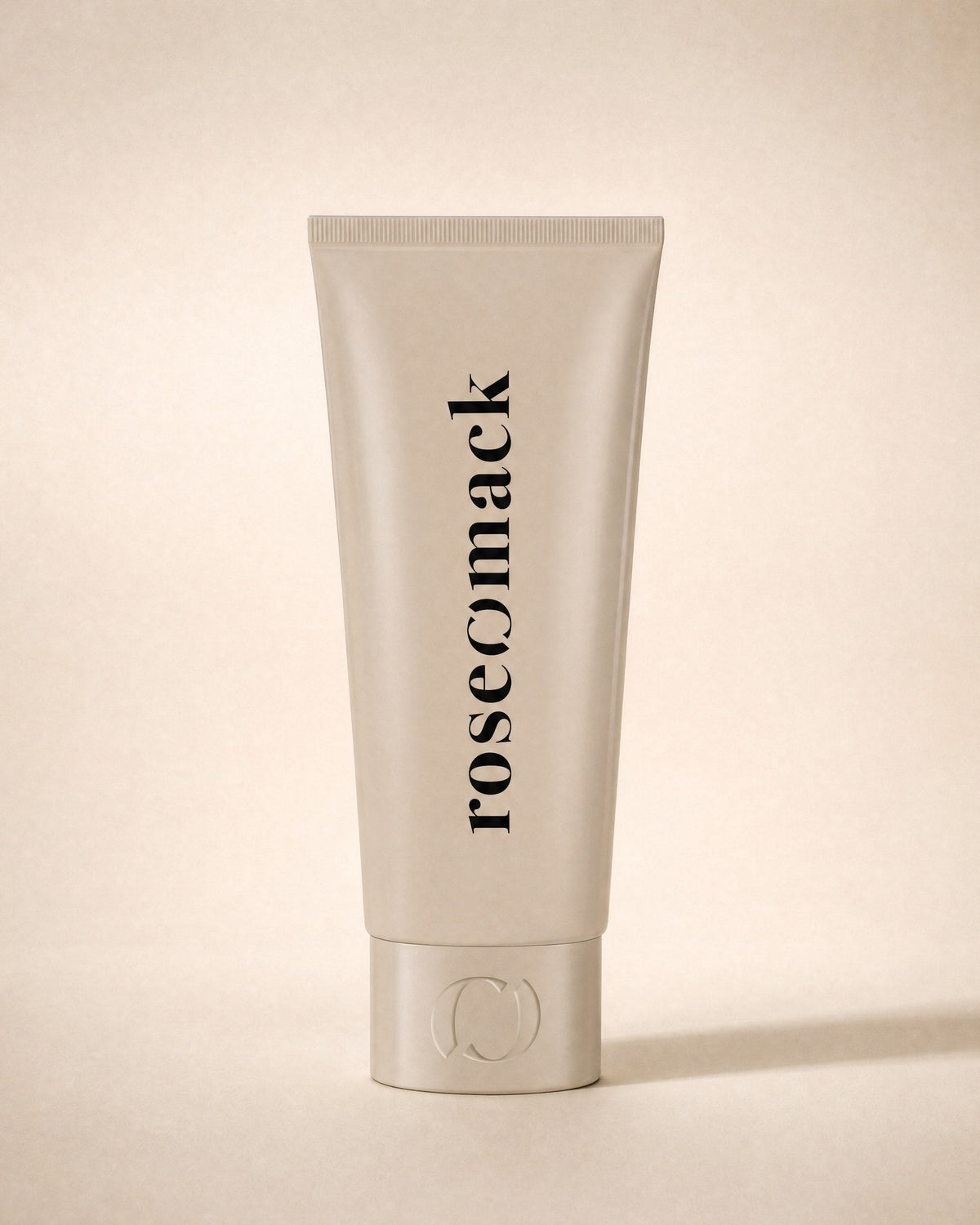 roseomack Sun protection tube seen front on, the wordmark running vertically, the broken O on the cap